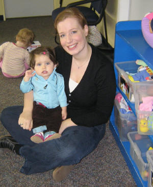 Photo of mother with small child in play area